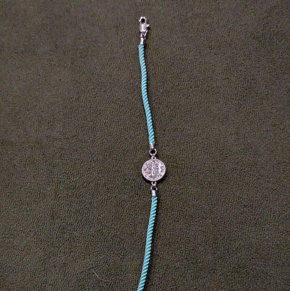 Rustic Cuff aqua blue rope style bracelet with silver logoed medallion
